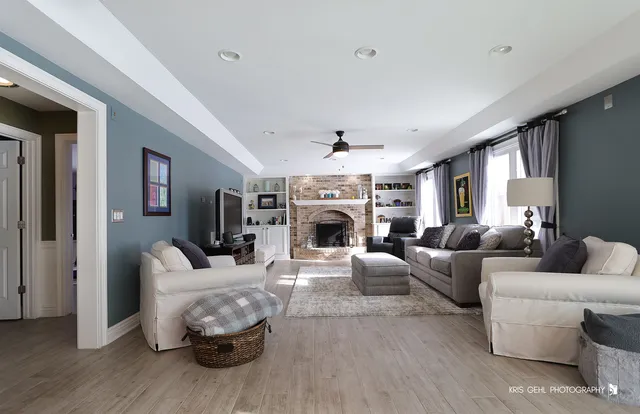 a living room with furniture a fireplace and a flat screen tv