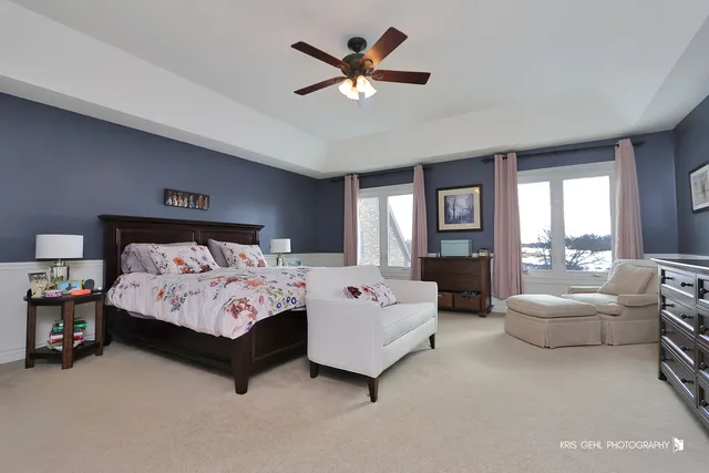 a bedroom with bed and glass window