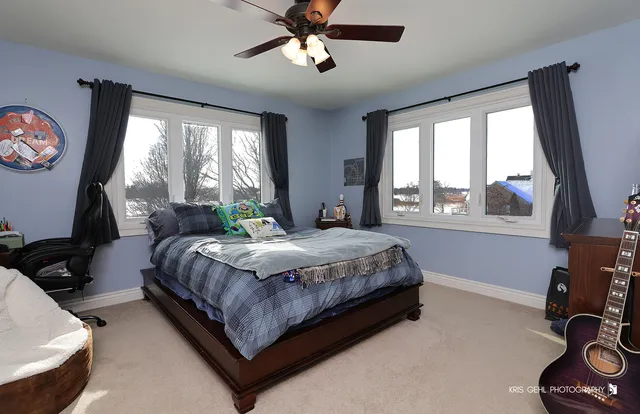 a bedroom with a large bed and a window