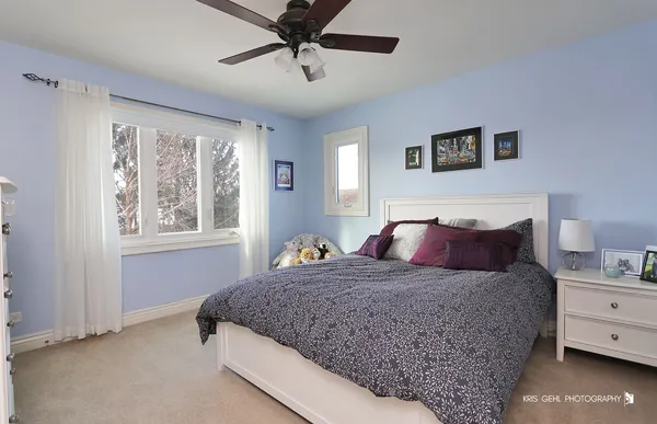 a bedroom with a large bed and a window