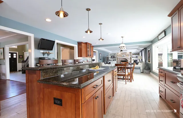a kitchen with stainless steel appliances granite countertop a stove and a wooden floors