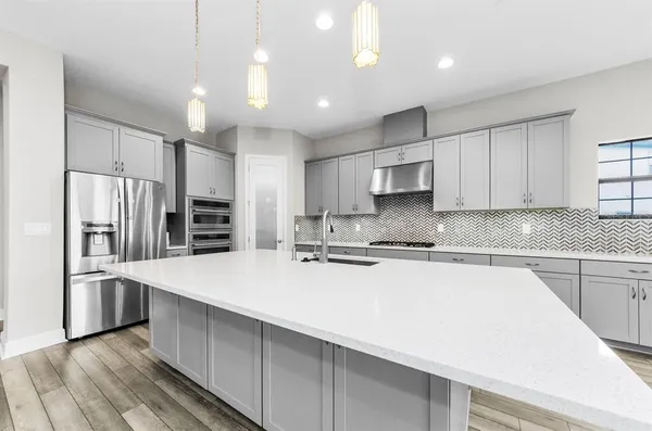a kitchen with granite countertop white cabinets a sink and dishwasher