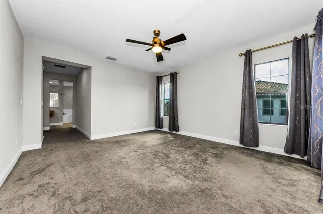 a view of empty room with ceiling fan