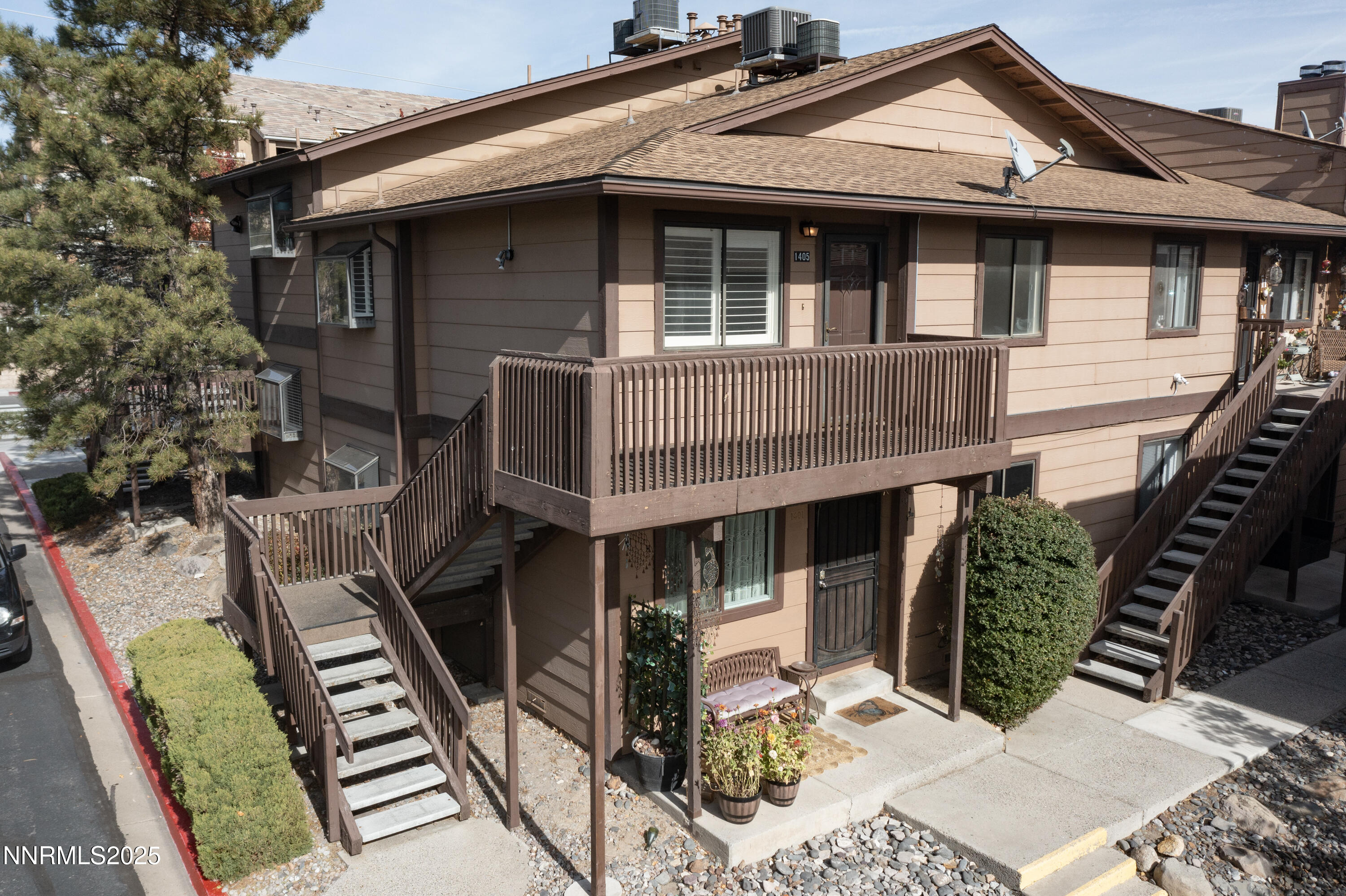 a front view of a house with balcony and outdoor seating