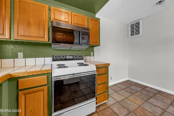 a kitchen with a stove and a microwave
