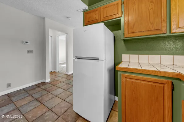 a white refrigerator freezer sitting in a kitchen