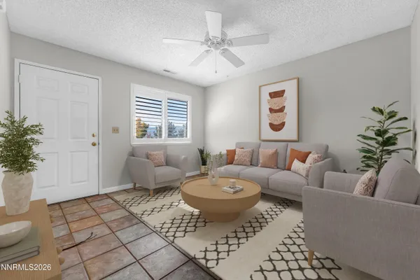 a living room with furniture and a potted plant