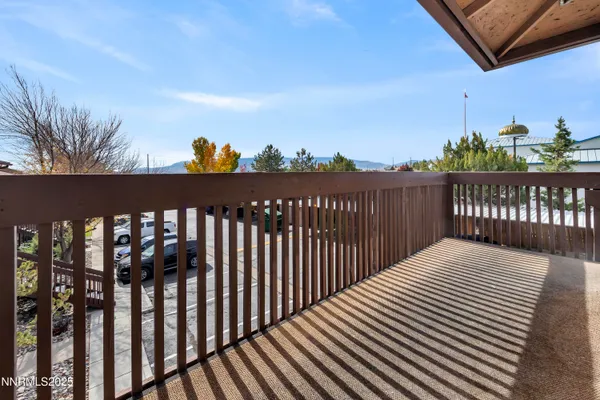 a view of a balcony with wooden floor