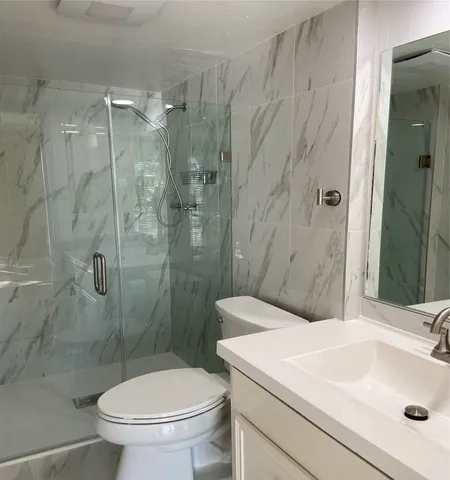 a bathroom with a sink toilet and shower