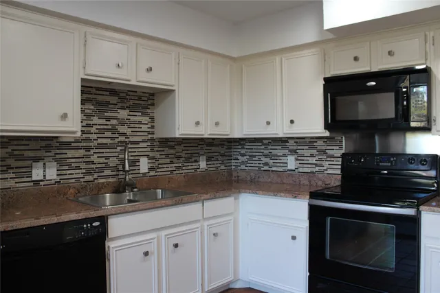 a kitchen with a sink and cabinets
