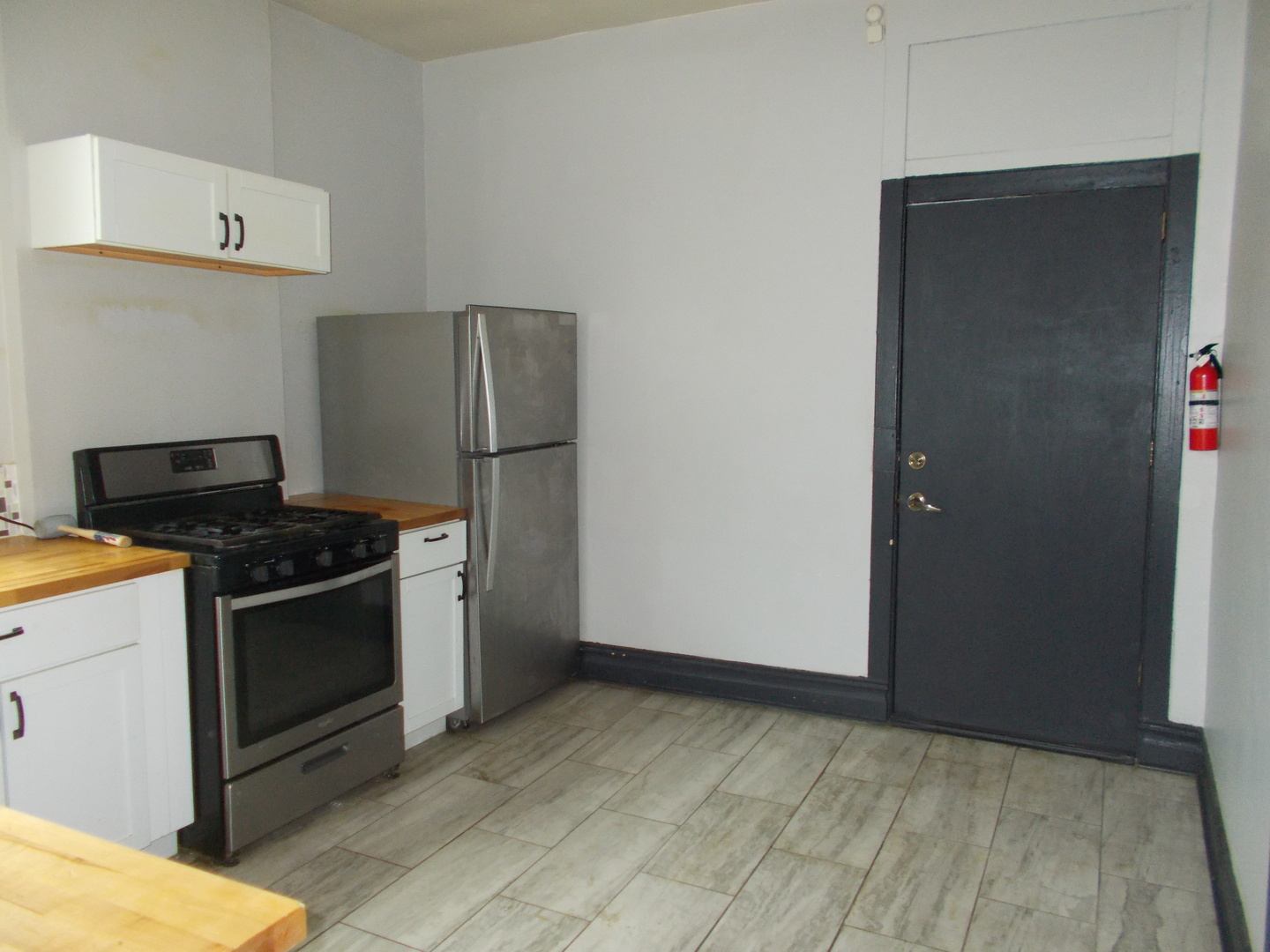 5715 South Sangamon Street, Unit 2 Chicago, IL 60621 - Photo 3 of 9 a kitchen with a stove and a refrigerator