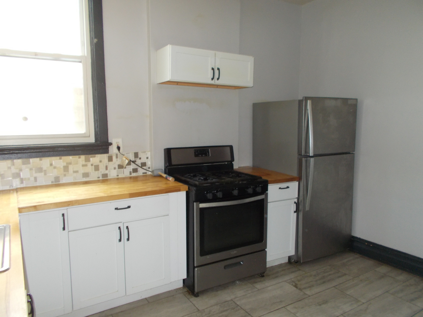 5715 South Sangamon Street, Unit 2 Chicago, IL 60621 - Photo 8 of 9 a kitchen with granite countertop cabinets and steel stainless steel appliances