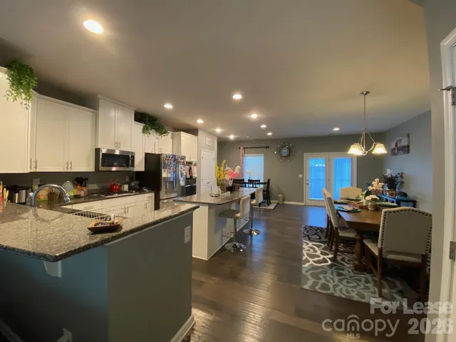 a kitchen with counter space appliances and a dining table