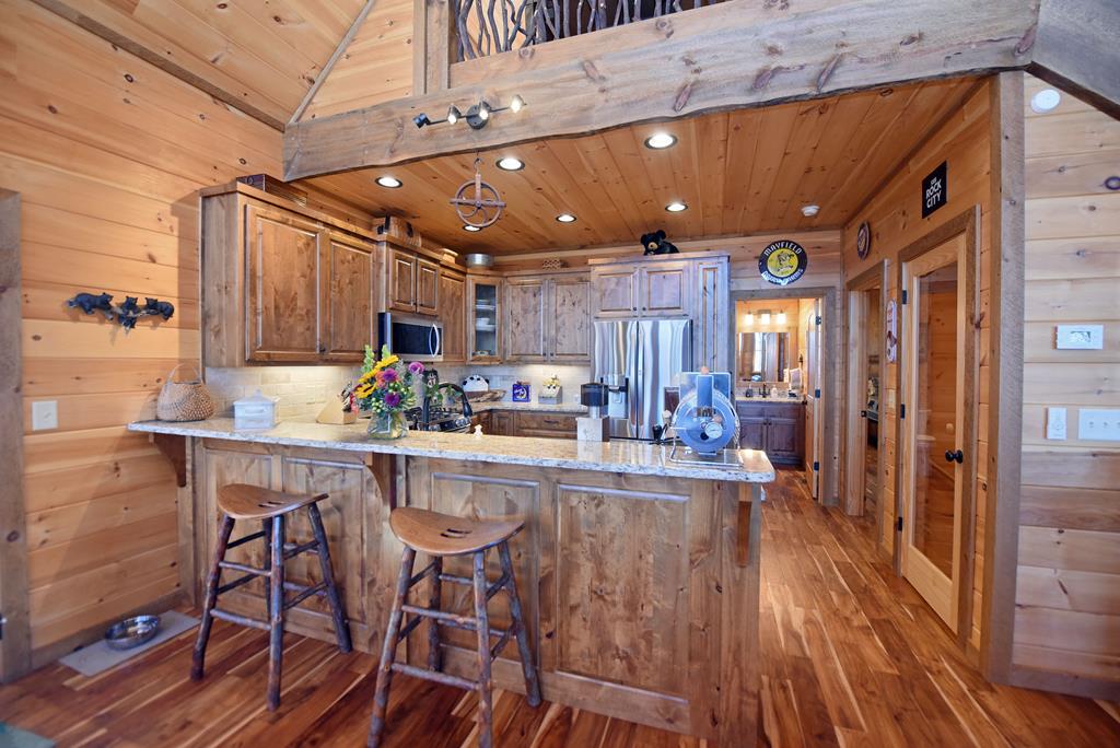 731 Native Trail Cherry Log, GA 30522 - Photo 25 of 56 a kitchen with kitchen island granite countertop wooden floors and center island