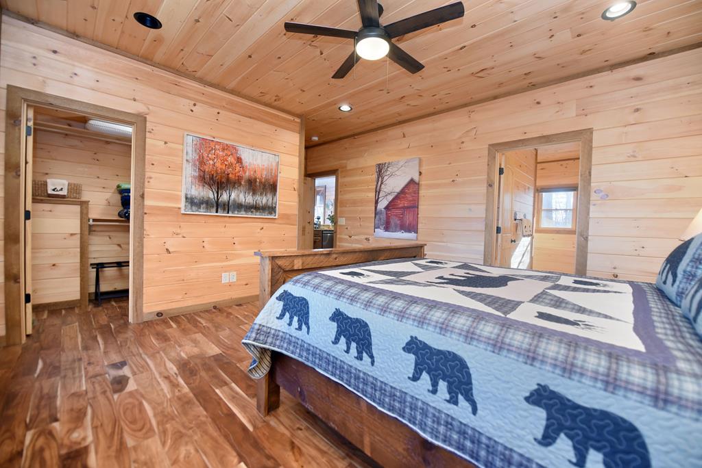 731 Native Trail Cherry Log, GA 30522 - Photo 32 of 56 a spacious bedroom with a bed and a chandelier