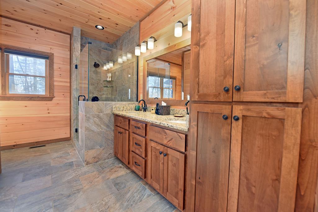 731 Native Trail Cherry Log, GA 30522 - Photo 33 of 56 a bathroom with a sink a mirror and a shower