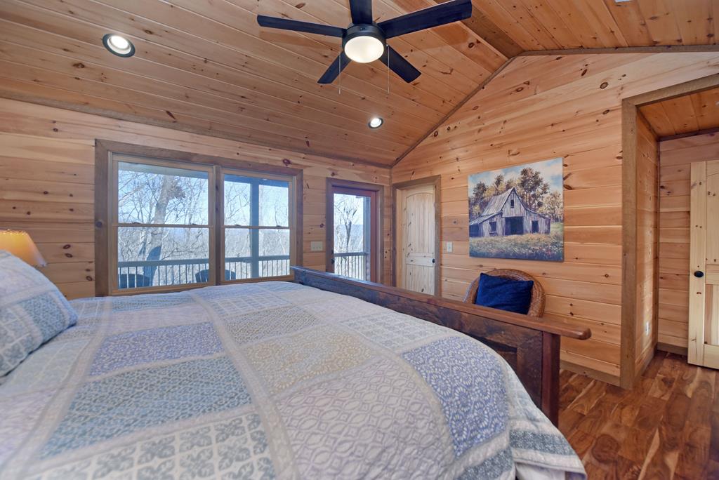 731 Native Trail Cherry Log, GA 30522 - Photo 39 of 56 a spacious bedroom with a large bed and a large window