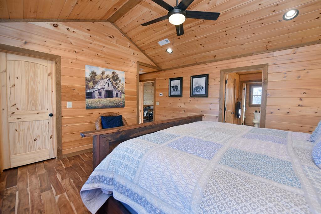 731 Native Trail Cherry Log, GA 30522 - Photo 42 of 56 a bedroom with a bed and a chandelier