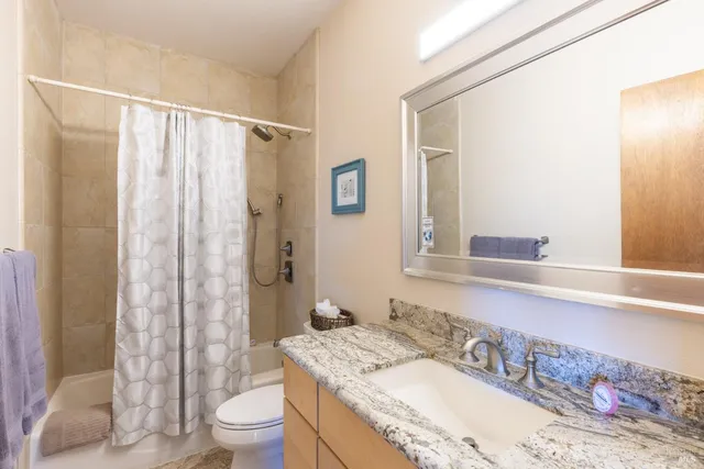 a bedroom with a bed and a dresser