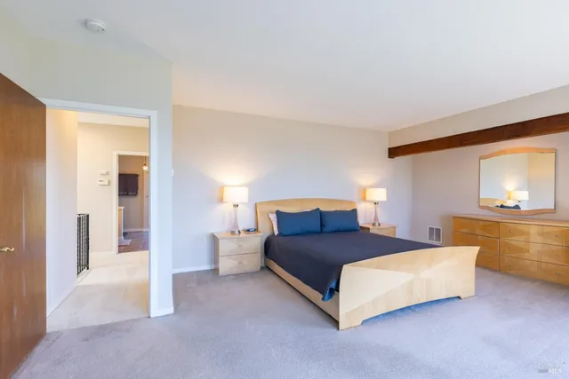 a bedroom with a large bed and a large window