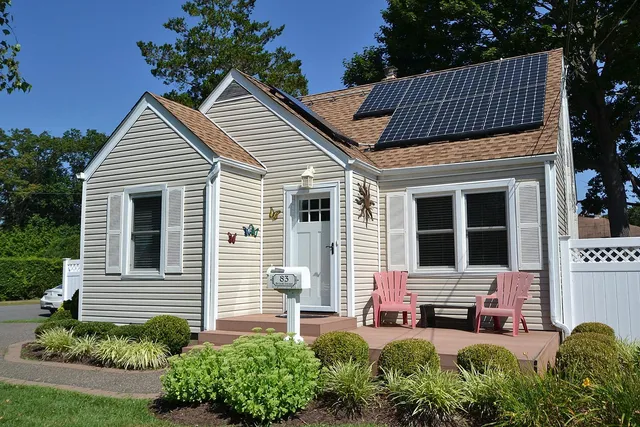 a view of a house with a yard and furniture