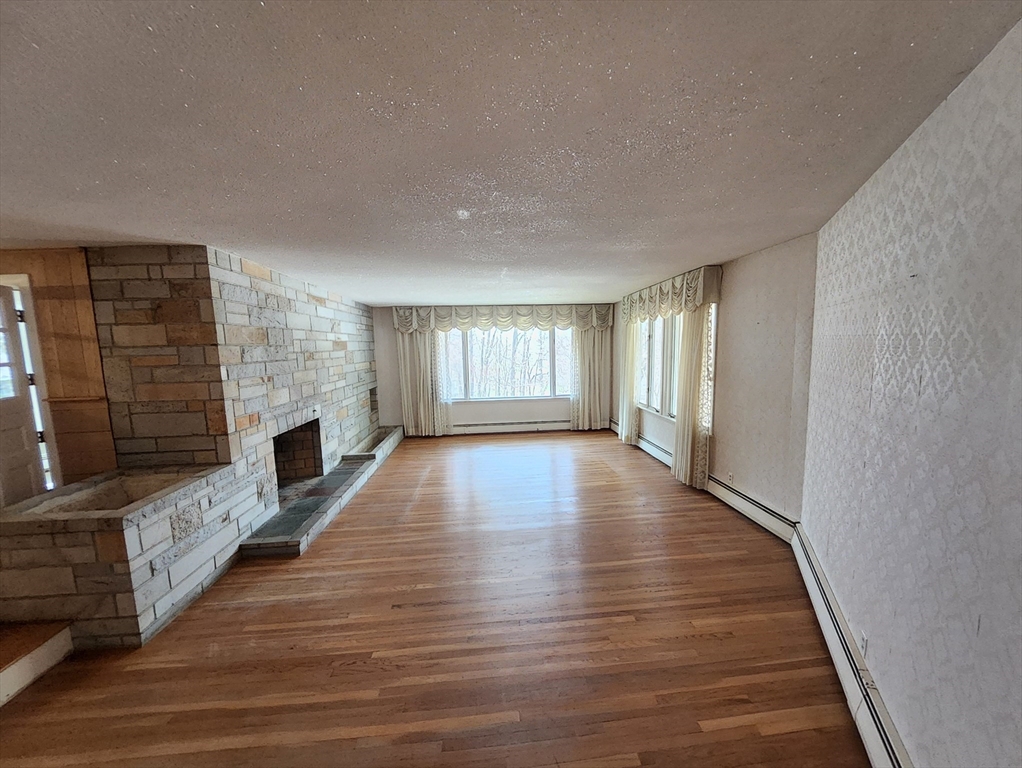 212 Chestnut Street Andover, MA 01810 - Photo 11 of 31 a view of an empty room with wooden floor and a window