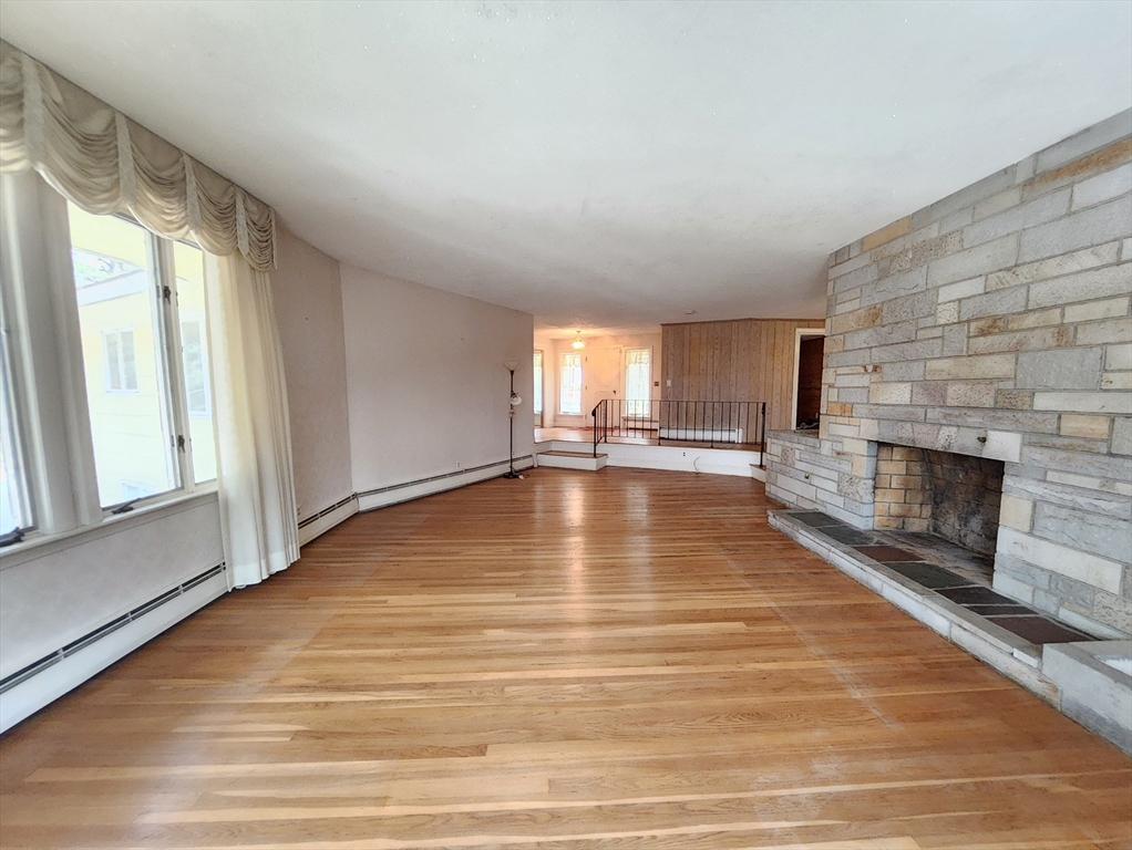 212 Chestnut Street Andover, MA 01810 - Photo 12 of 31 a view of empty room with wooden floor and fireplace