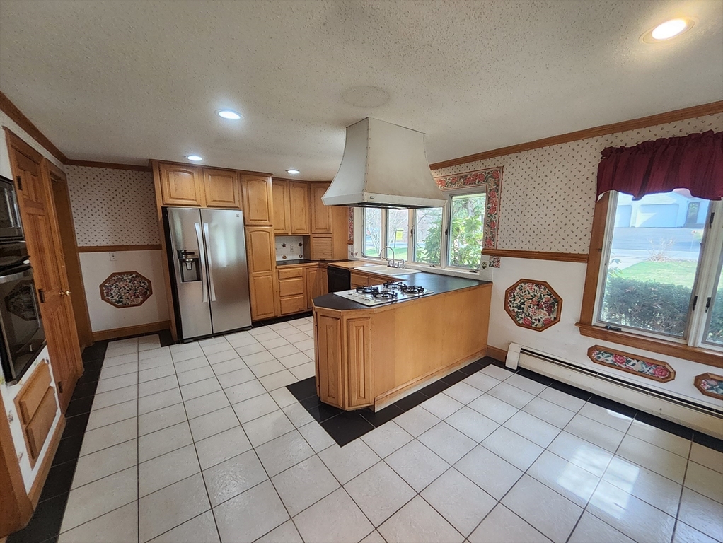 212 Chestnut Street Andover, MA 01810 - Photo 17 of 31 a kitchen with stainless steel appliances granite countertop a refrigerator a stove and a sink