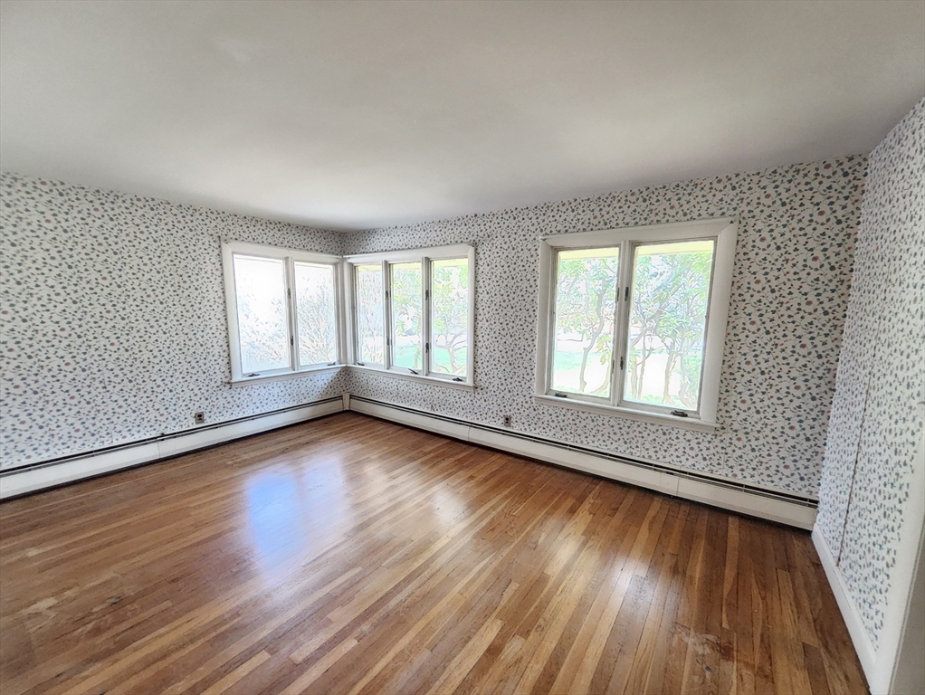 212 Chestnut Street Andover, MA 01810 - Photo 20 of 31 an empty room with wooden floor and windows