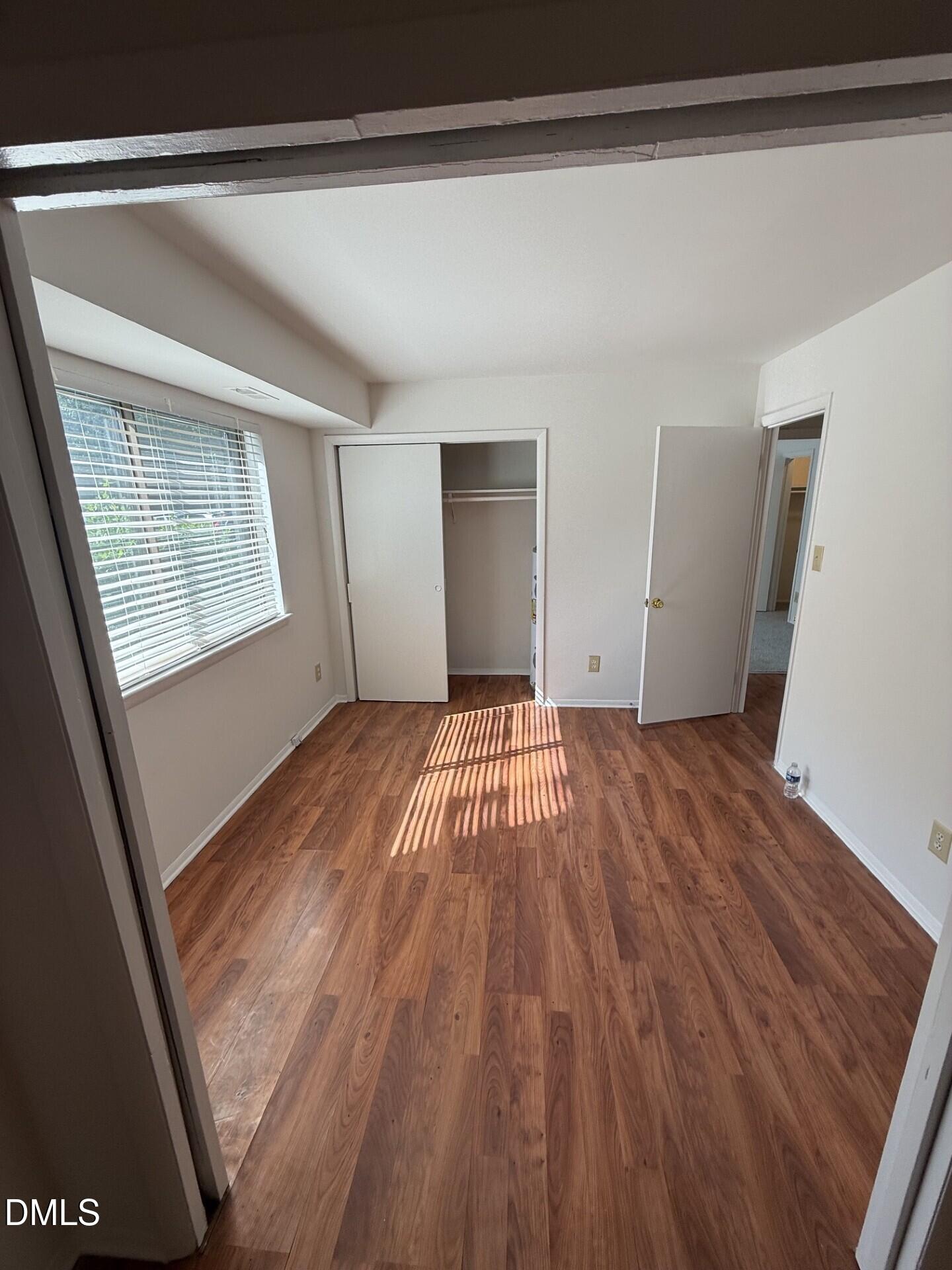 1299 Schaub Drive, Unit D Raleigh, NC 27606 - Photo 7 of 16 a view of empty room with wooden floor