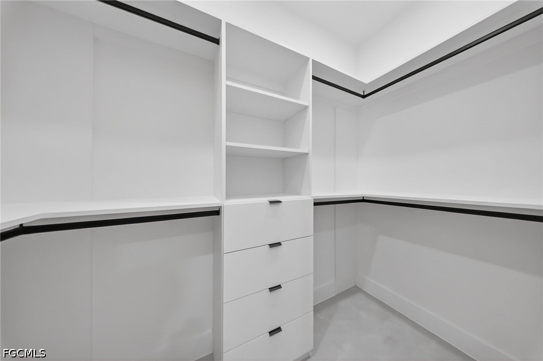 4213 25th Street Southwest Lehigh Acres, FL 33976 - Photo 16 of 47 a view of walk in closet with empty racks