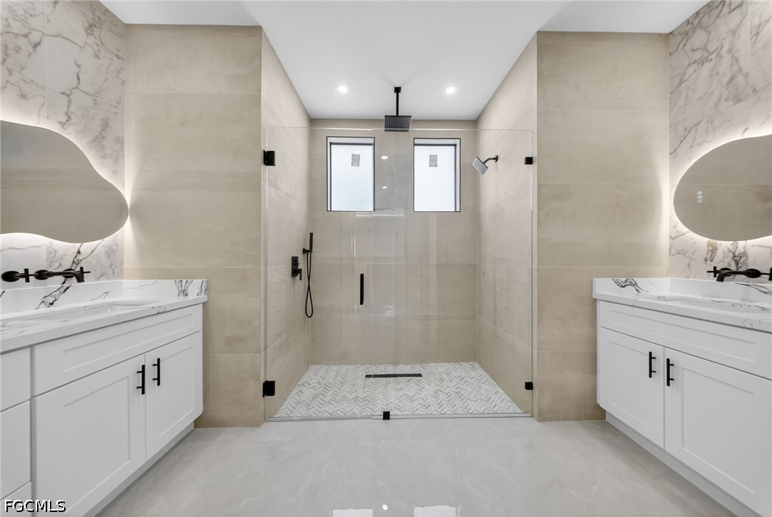 4213 25th Street Southwest Lehigh Acres, FL 33976 - Photo 19 of 47 a spacious bathroom with a double vanity sink mirror and