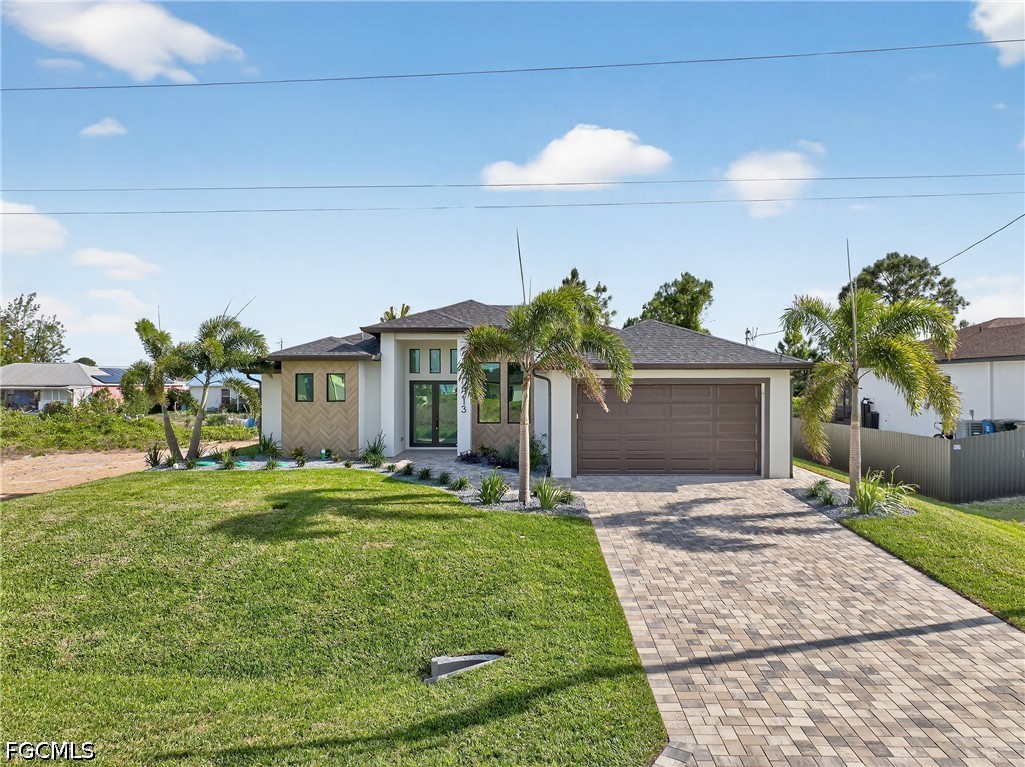 4213 25th Street Southwest Lehigh Acres, FL 33976 - Photo 2 of 47 a front view of a house with garden
