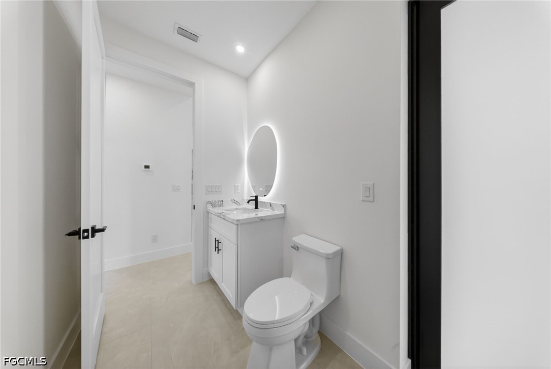 4213 25th Street Southwest Lehigh Acres, FL 33976 - Photo 24 of 47 a bathroom with a toilet sink and mirror