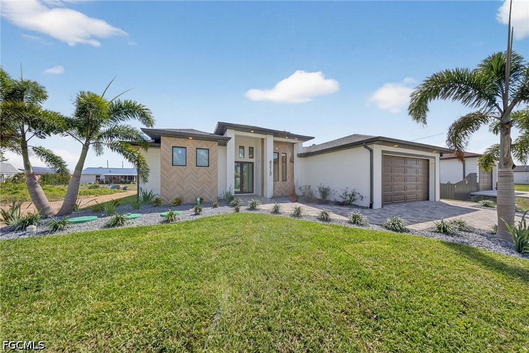 4213 25th Street Southwest Lehigh Acres, FL 33976 - Photo 3 of 47 front view of house with a yard and potted plants