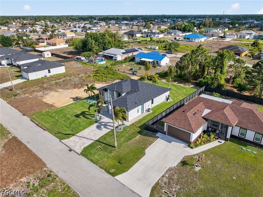 4213 25th Street Southwest Lehigh Acres, FL 33976 - Photo 44 of 47 an aerial view of residential houses with outdoor space