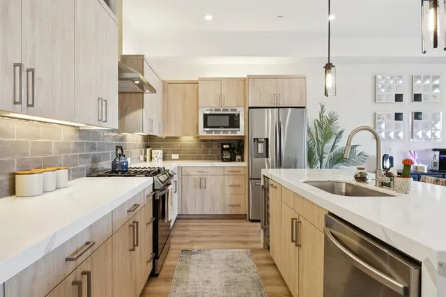a kitchen with a sink stove and refrigerator