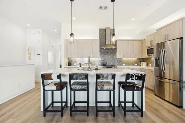 a kitchen with kitchen island granite countertop a sink and white appliances