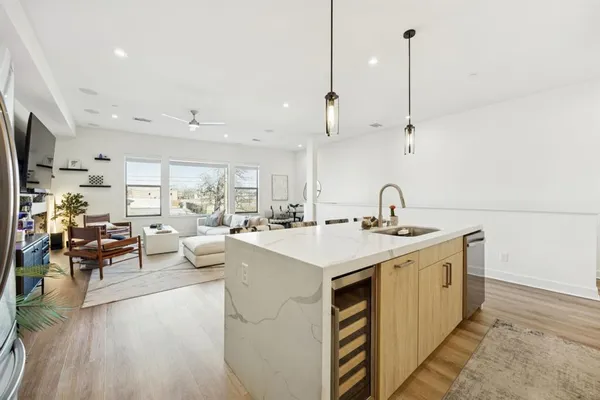 a open kitchen with stainless steel appliances granite countertop a sink stove and wooden floor