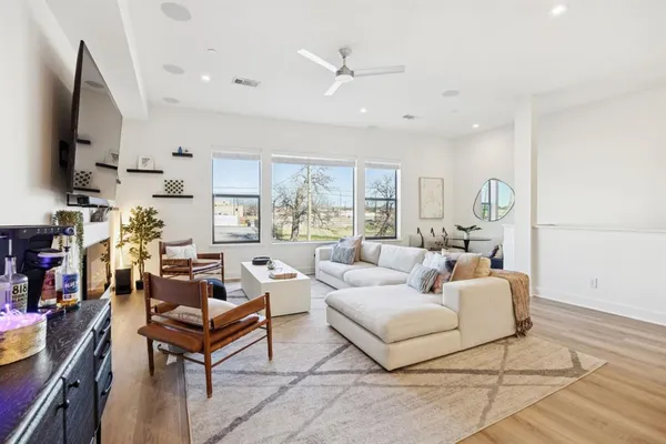 a living room with furniture a flat screen tv and a fireplace