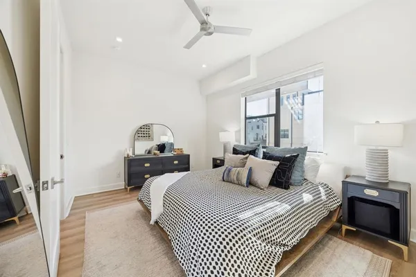 a bedroom with a bed and a window