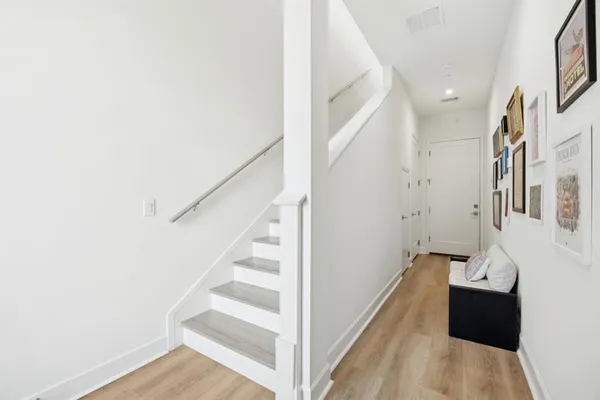 a view of entryway and hall with wooden floor