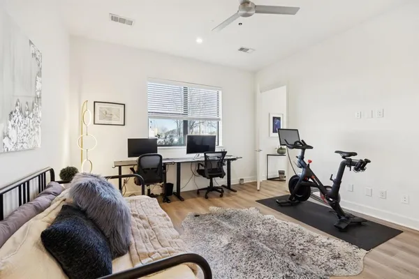 a living room with furniture gym equipment and a window