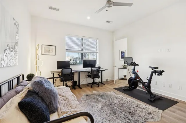 a living room with furniture gym equipment and a window