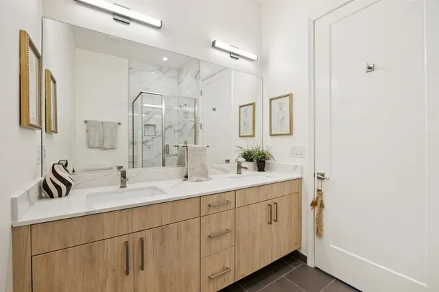a bathroom with a double vanity sink and mirror