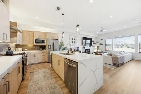 a kitchen with white cabinets and white appliances