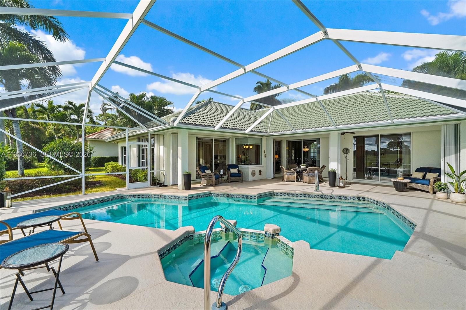 8185 Southeast Double Tree Drive Hobe Sound, FL 33455 - Photo 14 of 40 a view of a patio with table and chairs under an umbrella