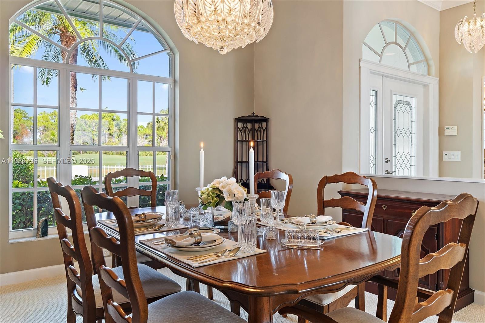 8185 Southeast Double Tree Drive Hobe Sound, FL 33455 - Photo 17 of 40 a view of a dining room with furniture window and outside view