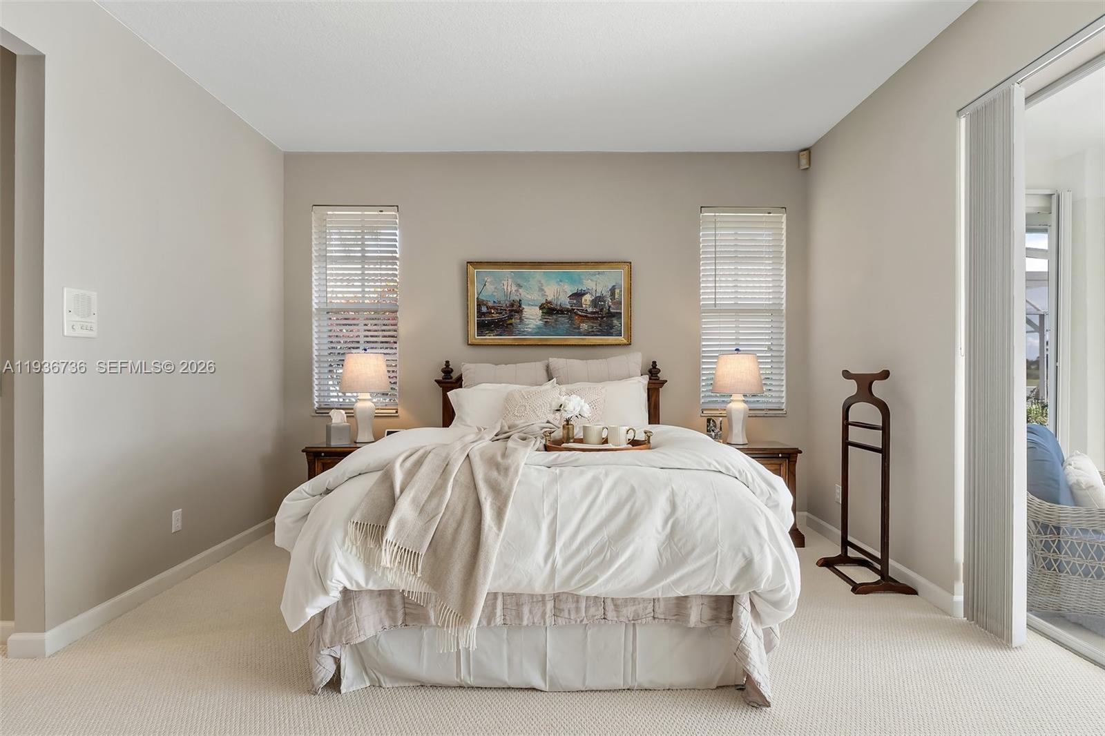 8185 Southeast Double Tree Drive Hobe Sound, FL 33455 - Photo 20 of 40 a bedroom with a bed and a window