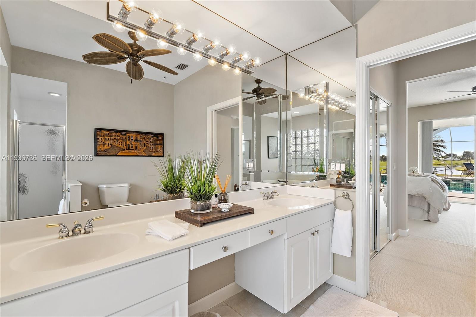 8185 Southeast Double Tree Drive Hobe Sound, FL 33455 - Photo 22 of 40 a bathroom with a sink double vanity and a mirror